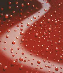 Water droplets on red surface